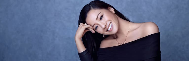 Constance Wu wearing luxury jewelry and a rose gold diamond watch