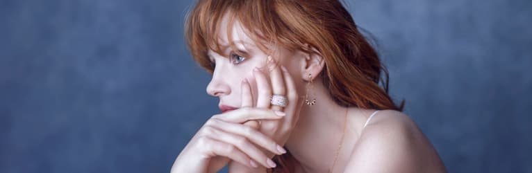 Jessica Chastain wearing a diamond ring and rose gold diamond earrings