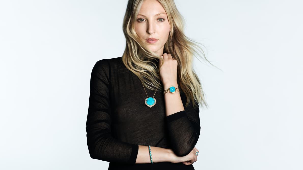 gold and turquoise women's watch paired with a long necklace