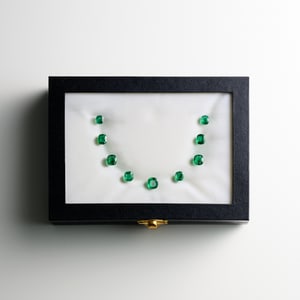 selection of emeralds in a box for a hight jewelry