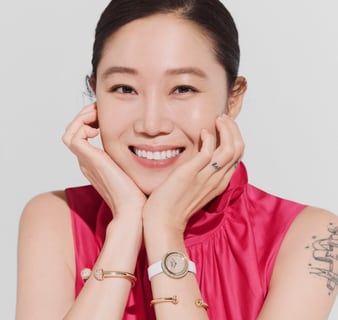 Kong Hyo Jin wearing a yellow gold diamond watch with diamond bangle bracelets