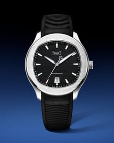 Brushed steel Piaget Polo watch with a black dial featuring a horizontal pattern and a textured black rubber strap.
